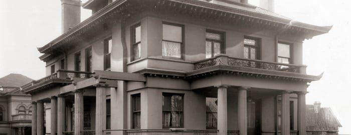 A black and white photograph of The Dearborn House, circa 1907, showcasing the building's stained glassed windows and Doric columns